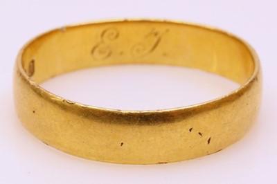 Lot 249 - A yellow metal wedding band, indistinctly...