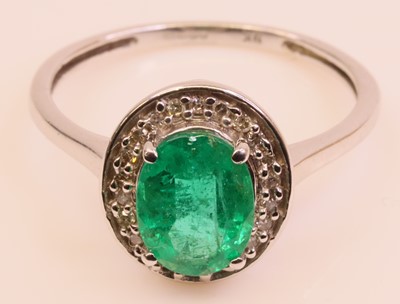 Lot 253 - A modern 9ct white gold, emerald and diamond...