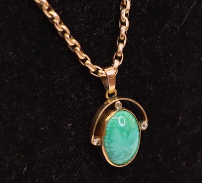 Lot 274 - A 9ct gold cabochon nephrite and diamond set...