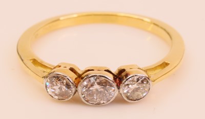 Lot 290 - An 18ct gold diamond three-stone ring,...