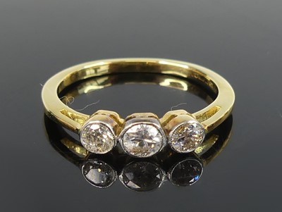 Lot 2560 - An 18ct gold diamond three-stone ring,...