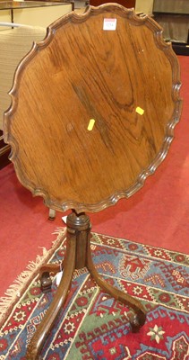 Lot 1254 - A walnut piecrust topped and tilt-top pedestal...