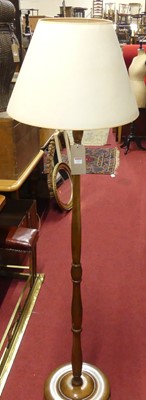 Lot 1315 - A turned walnut standard lamp with shade