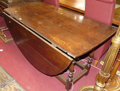 Lot 1320 - An antique joined oak drop leaf dining table,...