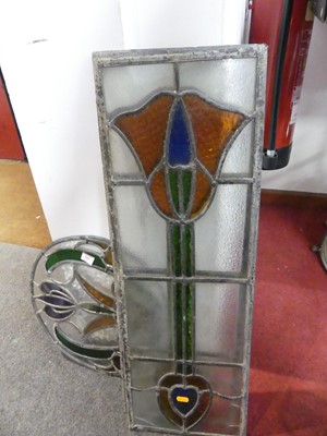 Lot 566 - A pair of leaded stained glass panels...