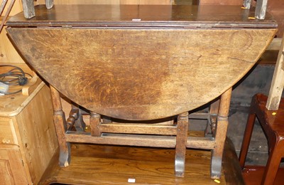 Lot 1391 - An antique joined oak dropflap gateleg...