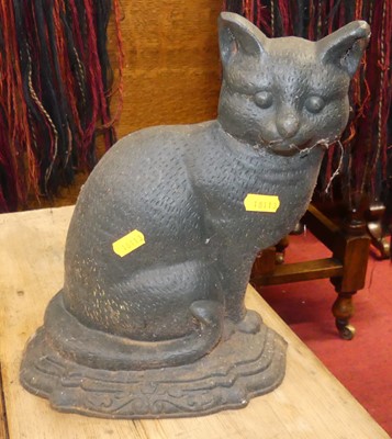 Lot 1394 - A cast iron doorstop in the form of a seated...