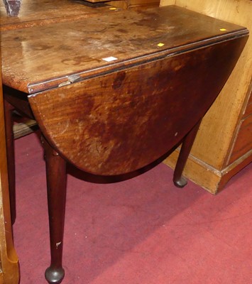 Lot 1404 - A George III mahogany dropleaf table, on pad...