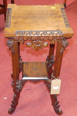 Lot 1422 - A relief carved oak square two-tier occasional...
