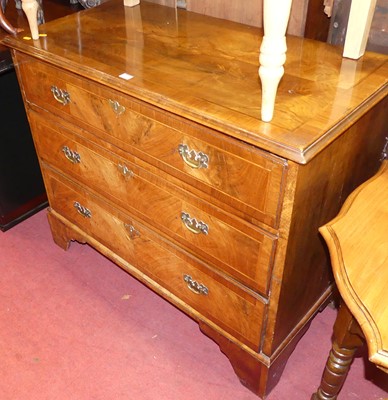 Lot 1425 - A figured walnut and crossbanded low chest of...
