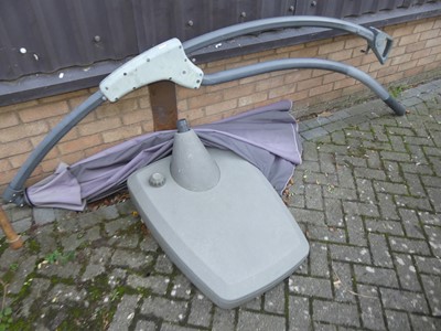 Lot 1435 - A curved garden parasol with base