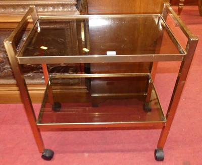 Lot 1454 - A gilt brass two-tier tea trolley, with smoky...