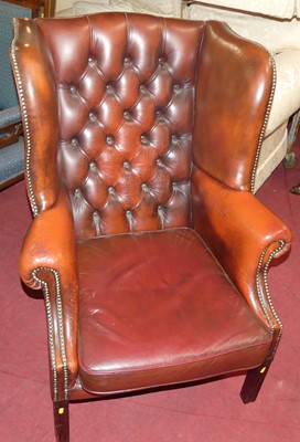 Lot 1456 - An ox-blood red leather upholstered button...