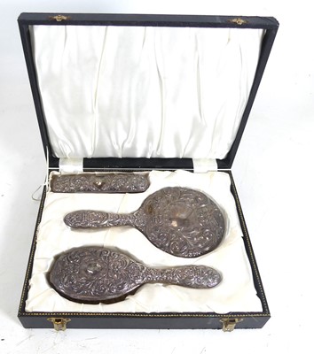 Lot 340 - A cased silver-backed vanity set, comprising...
