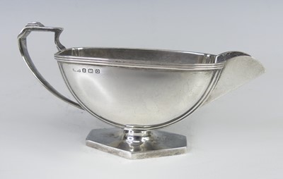 Lot 117 - An Art Deco silver cream jug, of bowed form...