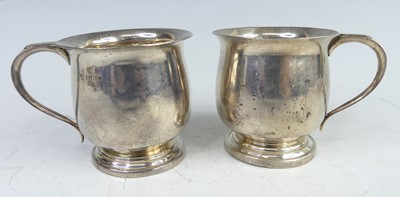 Lot 146 - A pair of 1960s silver footed christening mugs,...