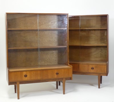 Lot 387 - A pair of 1970s teak bookcases, each having...