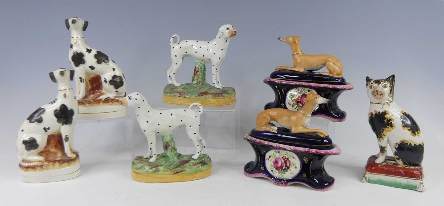 Lot 2043 - A pair of Staffordshire pug dogs, each with...