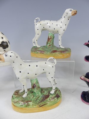 Lot 2043 - A pair of Staffordshire pug dogs, each with...