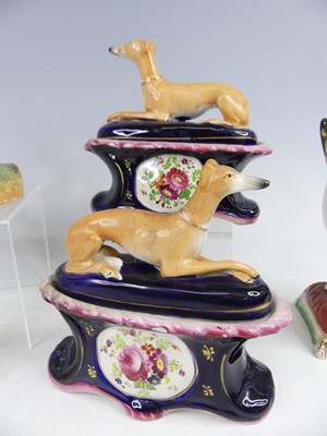 Lot 2043 - A pair of Staffordshire pug dogs, each with...