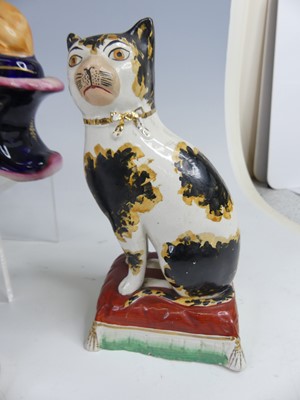 Lot 2043 - A pair of Staffordshire pug dogs, each with...