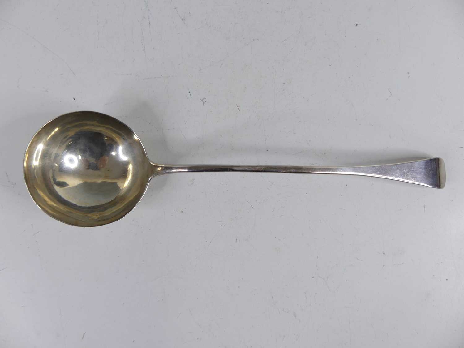 Lot 2098 - A George III silver soup ladle in the Old...