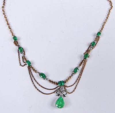 Lot 2292 - A rose and white metal emerald and diamond...