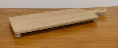 Lot 1518 - A contemporary oak cheeseboard on bun feet,...