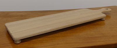 Lot 1519 - A contemporary oak cheeseboard on bun feet,...