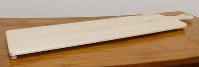 Lot 1520 - A contemporary maple cheeseboard on bun feet,...