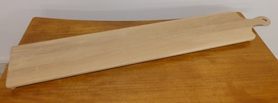 Lot 1516 - A contemporary oak cheeseboard on bun feet,...