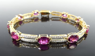Lot 2274 - A yellow metal tourmaline and diamond line...