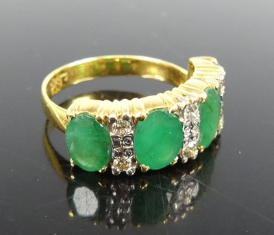 Lot 2289 - A yellow metal emerald and diamond half hoop...
