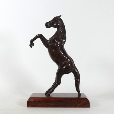 Lot 21 - A leather clad model of a rearing horse,...