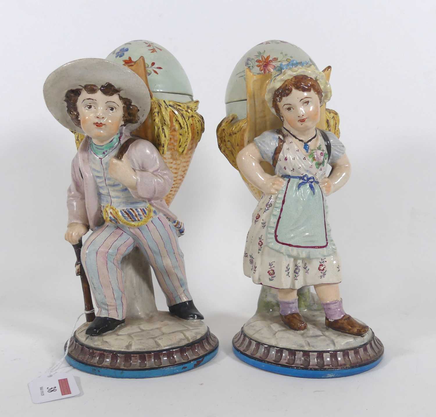 Lot 38 - A pair of continental pottery figural jars and...