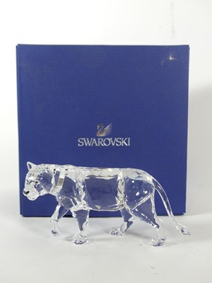 Lot 212 - A Swarovski crystal model of a lioness, l.15cm,...