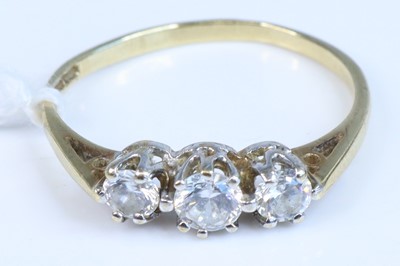 Lot 354 - A 9ct gold diamond three-stone ring, total...