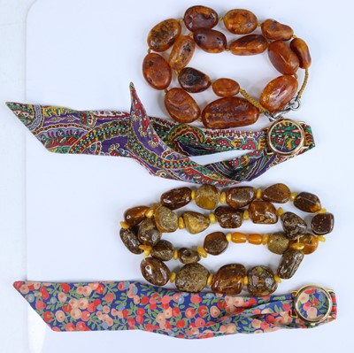 Lot 411 - An amber necklace, arranged as fifteen...