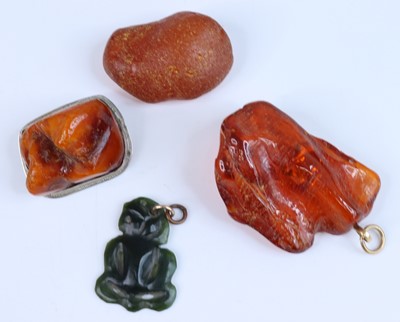 Lot 412 - A natural clear orange amber pendant, 5cm;...
