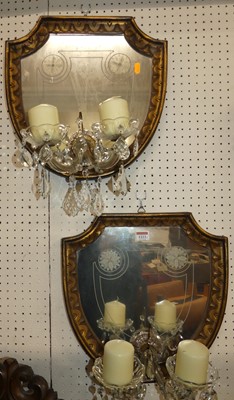 Lot 1223 - A pair of gilt wood shield shaped mirrored...