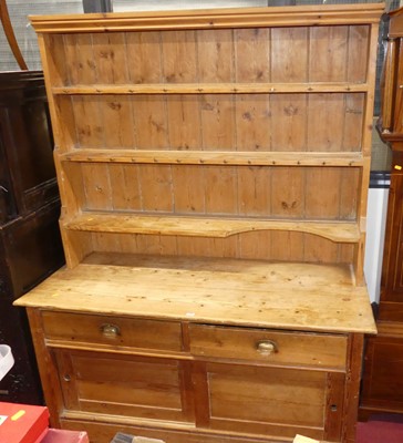 Lot 1239 - A rustic pine kitchen dresser, having...