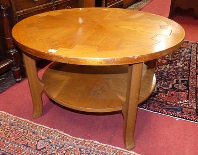 Lot 1285 - A 1980s teak circular two-tier coffee table,...