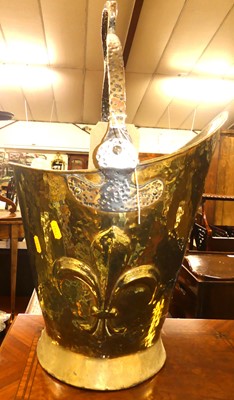 Lot 1294 - An Arts & Crafts brass helmet shaped coal...