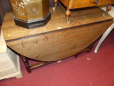 Lot 1307 - A joined oak drop-leaf dining table, having...