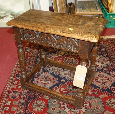 Lot 1318 - An antique joined oak joint stool with relief...