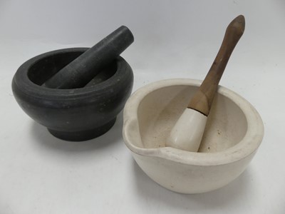 Lot 584 - A turned granite pestle and mortar, dia.19.5cm;...