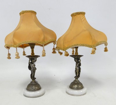 Lot 544 - A pair of patinated metal figural putti table...