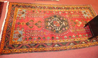 Lot 1245 - An Anatolian red ground rug, having floral...