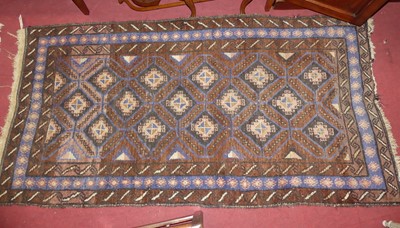 Lot 1247 - An Afghan woollen brown ground kelim rug with...
