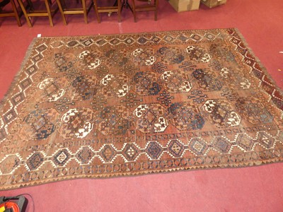 Lot 1252 - A Persian woollen brown ground Bokhara rug,...